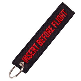 Keychain "Insert Before Flight" in black with red lettering